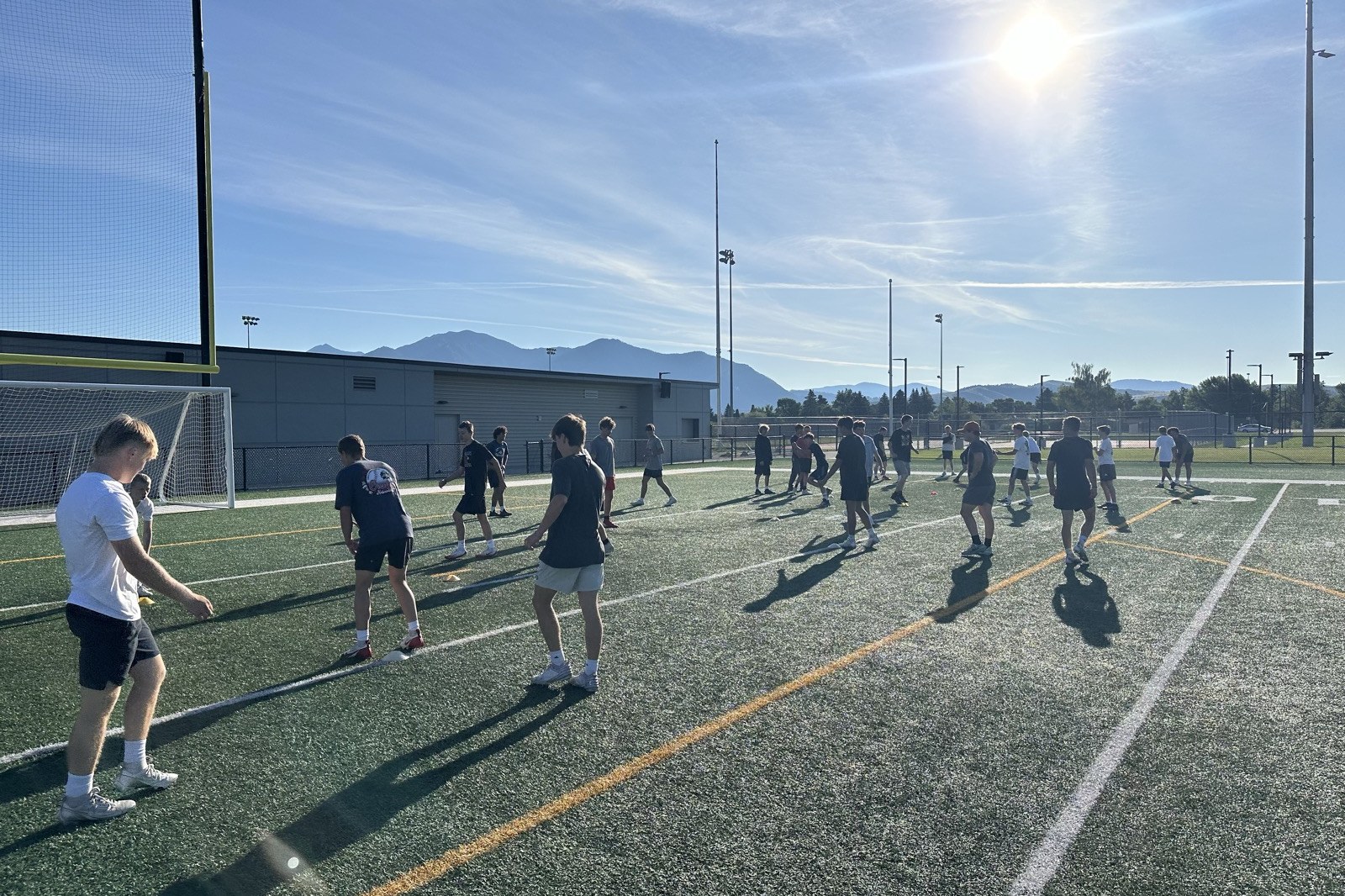 Gallatin Raptors football players training on the field with their coaching staff